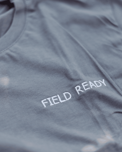 Gray shirt with 'FIELD READY' text on a close-up view